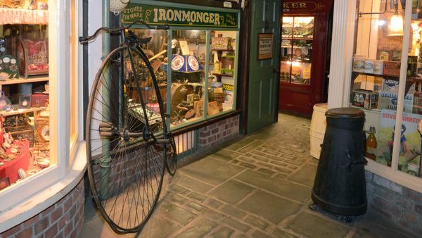 Penny farthing cycle outside a mock Victorian shop