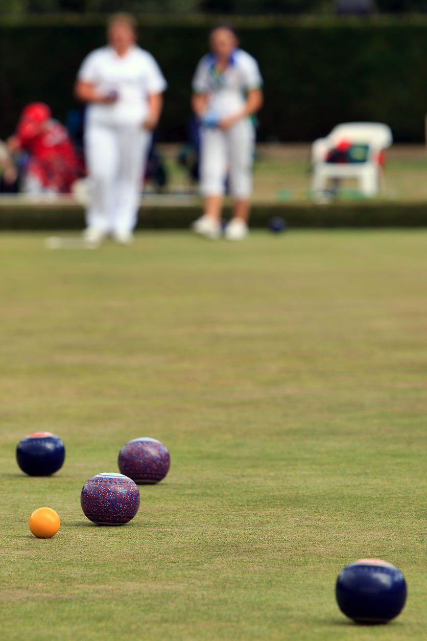 Ladies playing lawn bowls in Devon - focus on the jack.